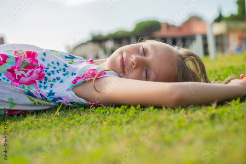 Close up of girl falling asleep on grass during vacations