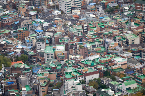 Aerial view to the apartments with a green roof in Seoul in South Korea from the top of Inwangsan mountain.