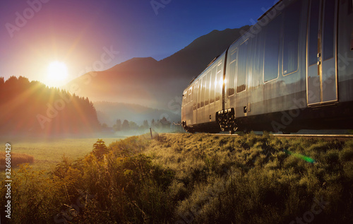 Obraz na płótnie Railway and train in the Alpes at sunrise