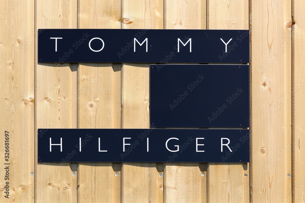 Villefranche, France - June 11, 2017: Tommy Hilfiger logo on a wall. Tommy  Hilfiger is an American multinational that designs and manufactures upper  market apparel for men, women and children Stock Photo | Adobe Stock