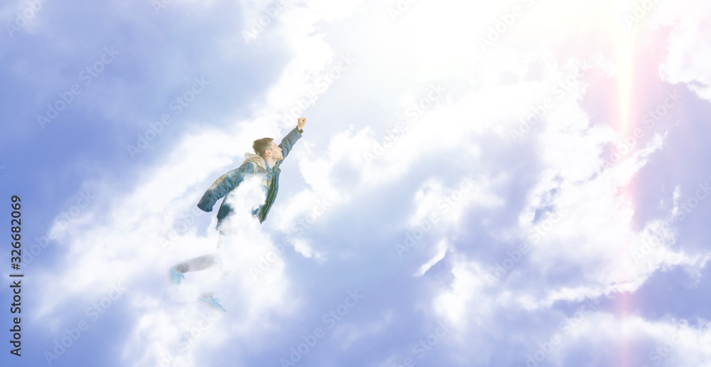 superhero concept, the city needs a hero, young male flying high above in the clouds