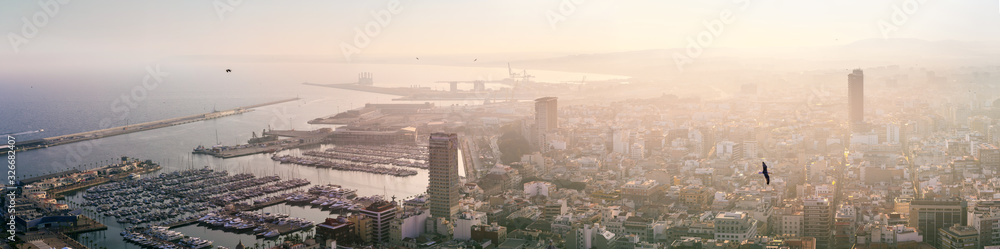 Breathtaking aerial panoramic view from Mount Benacantil of beautiful sunset over old part city of Alicante. Costa Blanca. Alicante, province of Valencia, Spain.