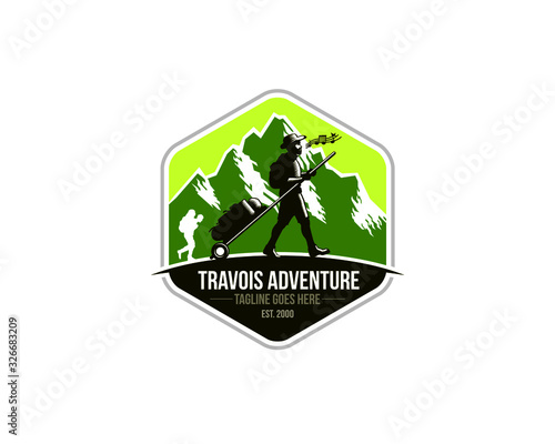 emblem logo of sherpa trekker pulling travois walking on the ground in front of mountains 