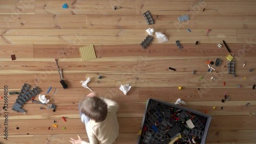 House cleaning. Mom and child clean up the mess on the floor in the apartment, timelapse, view from above
