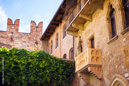 Courtyard of Casa di Giulietta House of Juliet with famous balcony of Juliet from drama William Shakespeare Romeo and Juliet in Verona, Italy. Romantic travel tourism destination photo