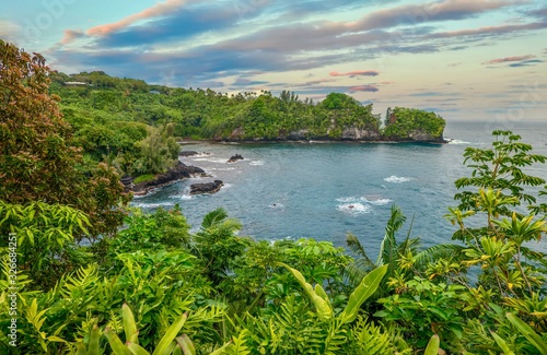 A beautiful secluded bay near Hilo, Hawaii, with lush tropical vegetation and picturesque scenery. photo