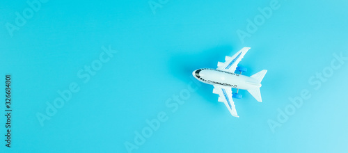 Top view airplane model on blue background with copy space for text