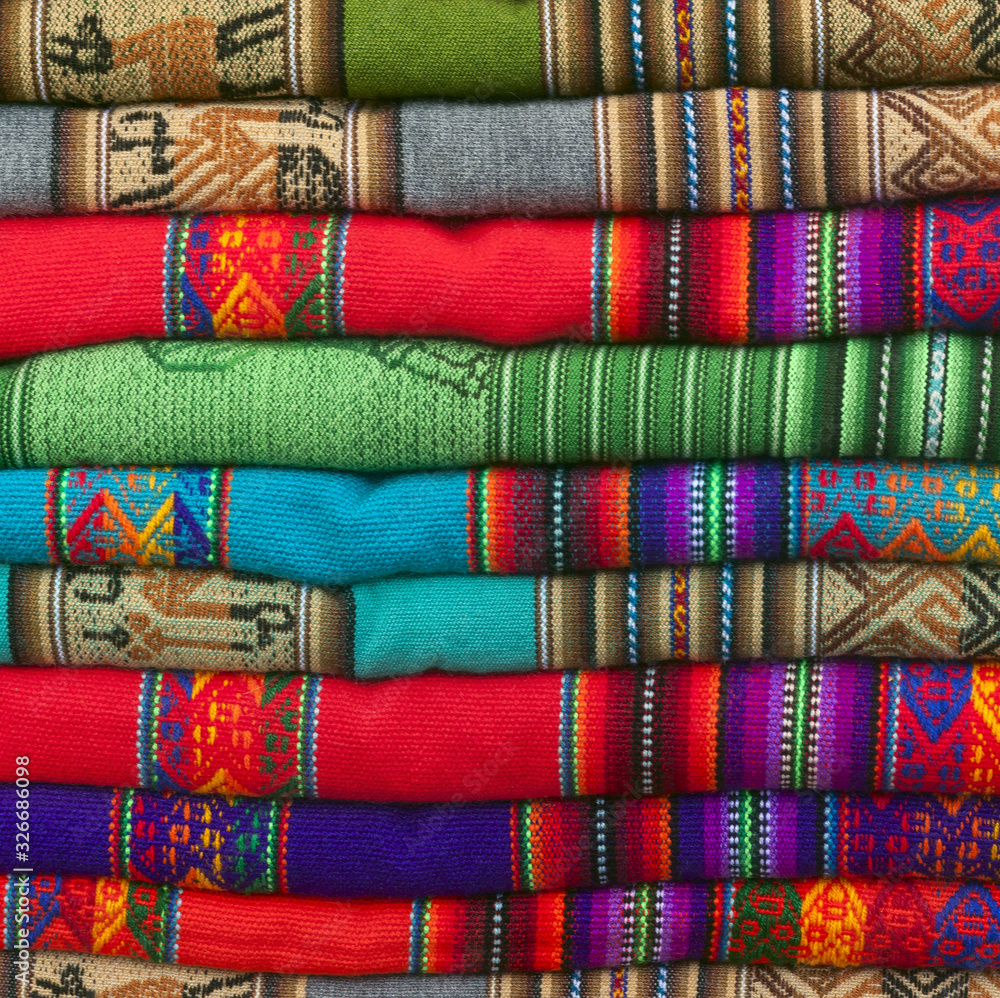 A pile of colorful Andean textiles photographed in the local handicraft market of Cusco A pile of colorful Andean textiles photographed in the local handicraft market of Cusco