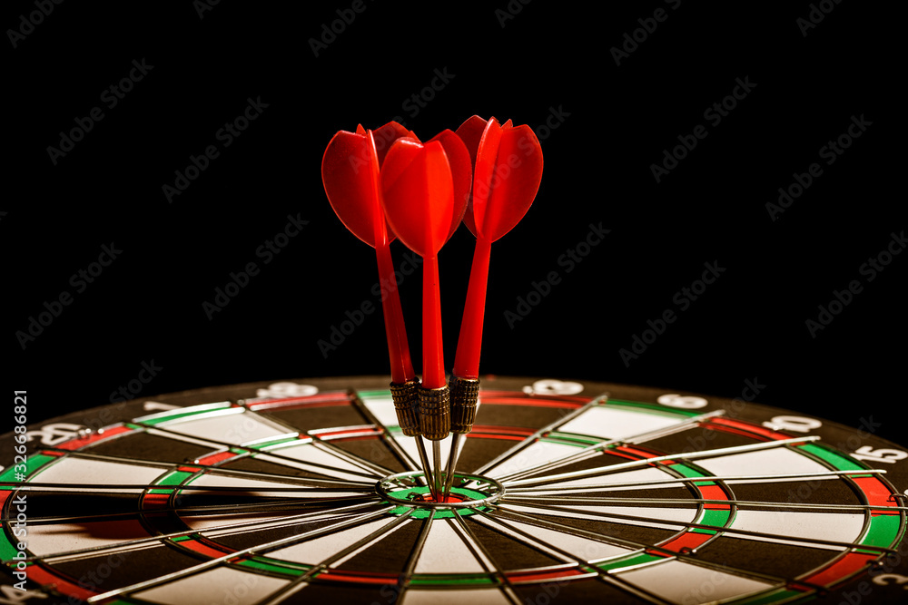 Fototapeta premium Red three darts arrows in the target center