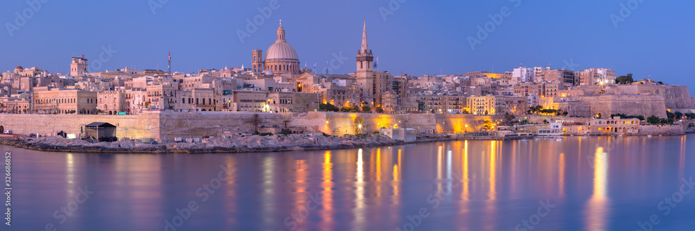 Panorama of Valletta with Our Lady of Mount Carmel church and St. Paul's Anglican Pro-Cathedral at sunset as seen from Sliema, Valletta, Malta