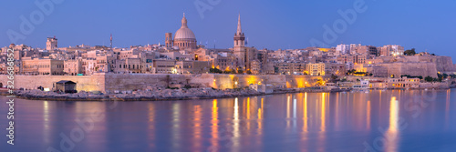Panorama of Valletta with Our Lady of Mount Carmel church and St. Paul's Anglican Pro-Cathedral at sunset as seen from Sliema, Valletta, Malta © Kavalenkava