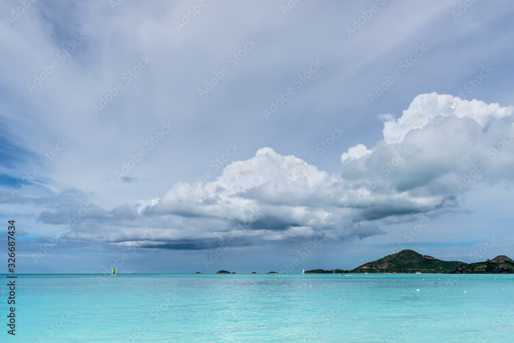 Beautiful marine view on tropical caribbean beach with turquoise water under blue sky and clouds at sunny day as natural background - Valley Church Beach at Antigua and Barbuda islandsland