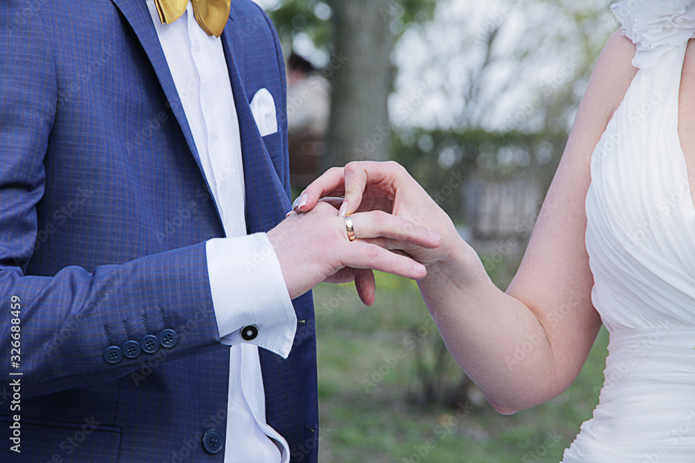 hands of the bride and groom and the bride wears a ring to the groom hands of the bride and groom and the bride wears a ring to the groom