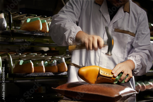Expert Italian craftsman at work in a luxury shoe factory