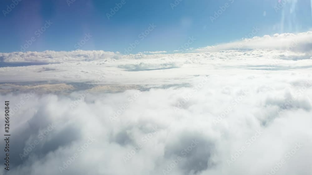 4k video through the airplane window on beautiful clouds and bright sun in blue sky 4k video through the airplane window on beautiful clouds and bright sun in blue sky