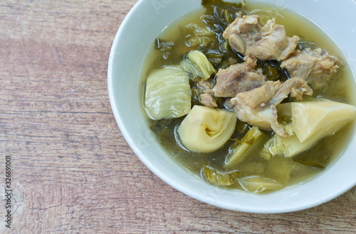 boiled pickled cabbage with pork bone in clear soup on bowl