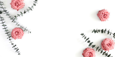 Beautiful flowers composition. Eucalyptus leaves and branches, pink rose flowers on white background. Valentines Day, Easter, Birthday, Happy Women's Day, Mother's day. Flat lay, top view, copy space 