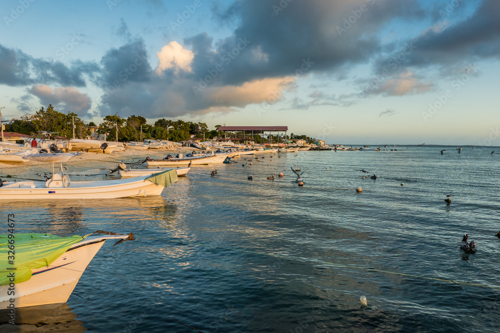 Obraz premium Boats anchored during a dramatic and beautiful sunset. Los Roques National Park, Venezuela