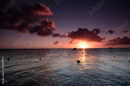 Принти на полотні Boats anchored during a dramatic and beautiful sunset