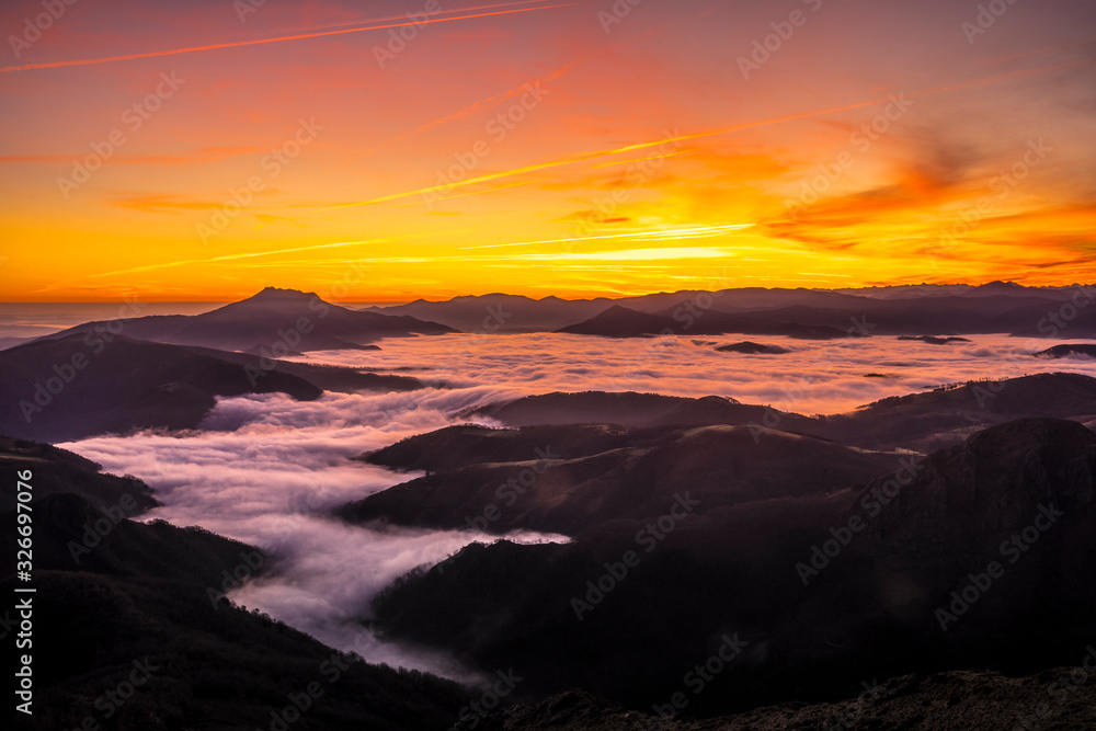 Detail of the beautiful fog between the mountains of the Basque country next to Mount Larrun in the golden hour Detail of the beautiful fog between the mountains of the Basque country next to Mount Larrun in the golden hour