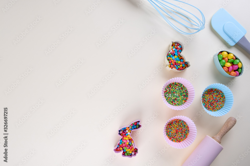 Preparation of gingerbread cookies. Easter cookies cutters, tools necessary to make gingerbread pastry, colored sprinkles. Easter concept.