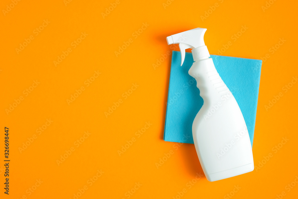 Cleaning spray bottle on blue sanitary napkin over orange background. Flat  lay, top view. House cleaning service concept Stock 写真 | Adobe Stock