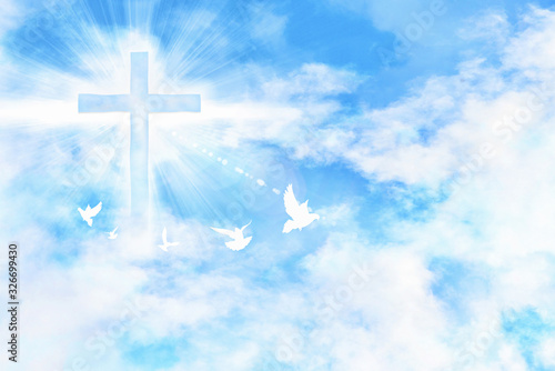 Foto Cloudy blue sky with cross and doves flying