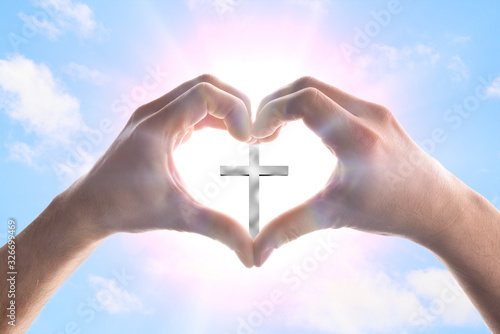 Photography Hands forming a heart in heaven with spikes surrounding cross