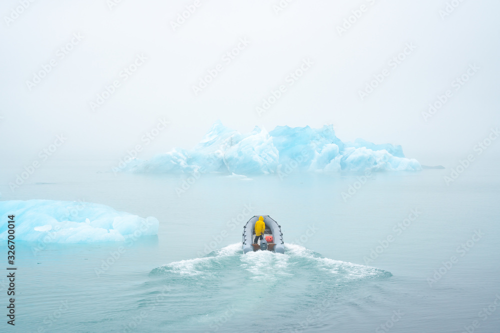 Naklejka premium scientists on the boat study the melting of icebergs due to global warming