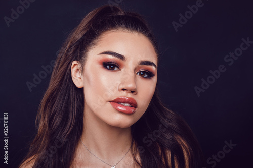 Portrait of a sexy young woman with beautiful makeup and shiny lips.