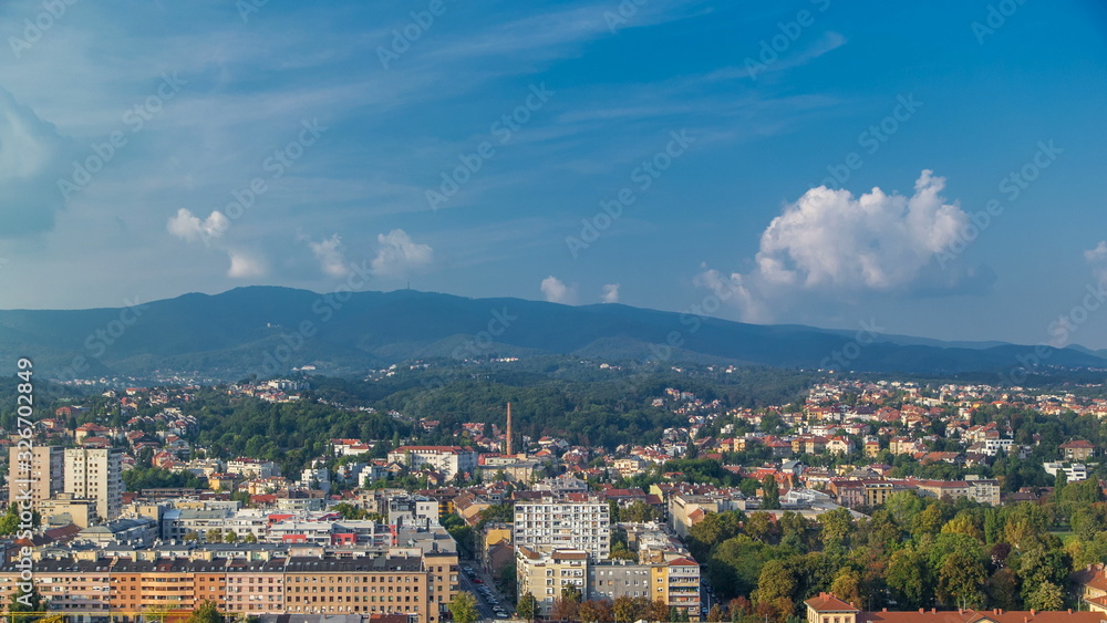 Panorama of the city center timelapse of Zagreb, Croatia, with modern and historic buildings, mountains on background.