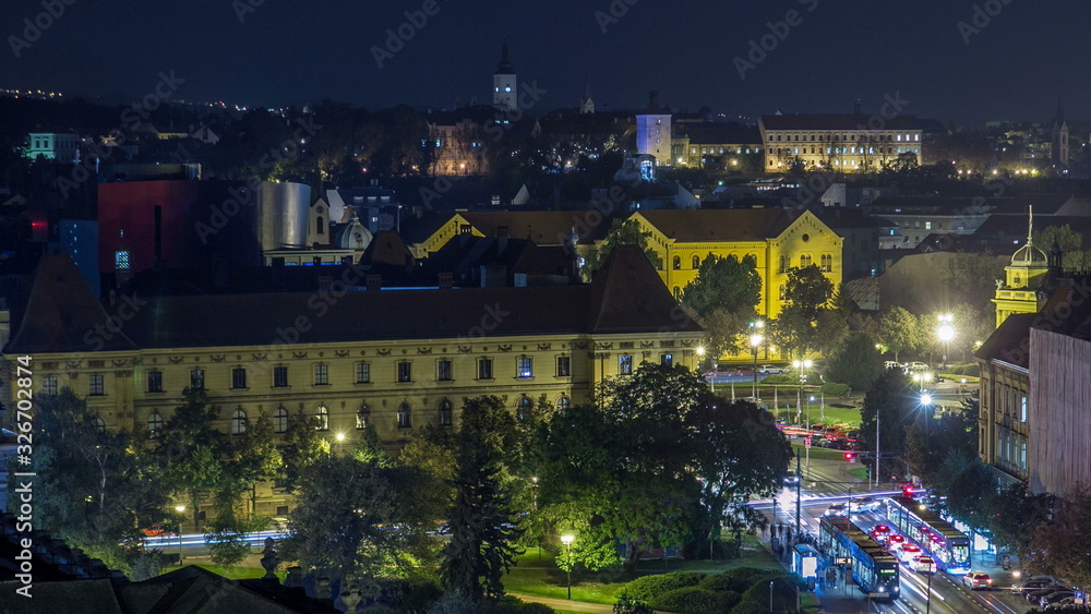 Naklejka premium Panorama of the city center night timelapse shoot from top of the skyscraper with a view to the intersection in front of national theater and museum in Zagreb, Croatia.