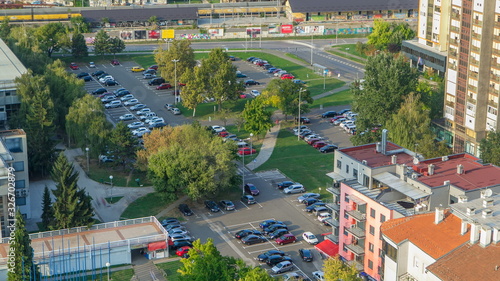 Cars moving on parking lot timelapse with green trees. CROATIA, ZAGREB