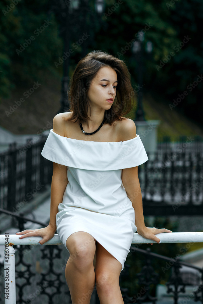 Fashionable girl wears white dress