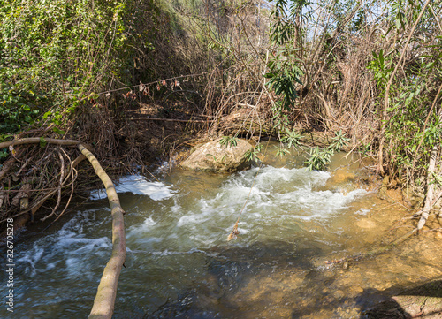 The rapid,  shallow, cold mountain Ayun river in the Galilee in northern Israel photo