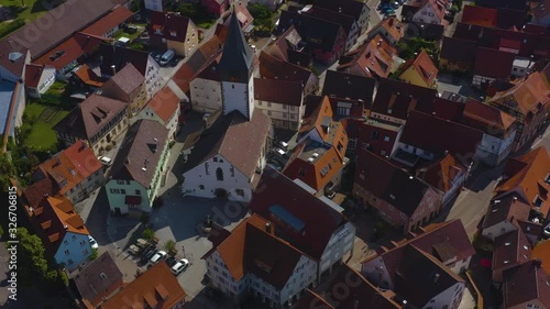 Aerial view from the old part of the city Niedernhall in Germany.  Low angle shot over Laurentius Church. Camera rotates right. photo