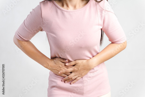 Wallpaper Mural Young beautiful woman having painful stomachache on white background.Chronic gastritis. Abdomen bloating concept. Torontodigital.ca