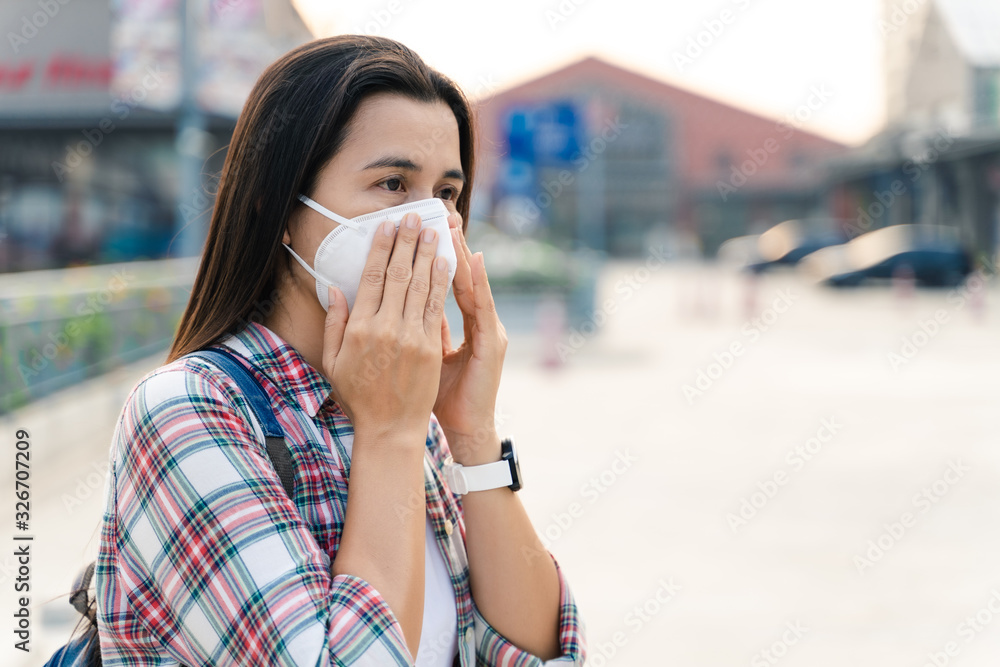 Asian woman wearing N95 mask to protect pollution PM2.5 and virus. COVID-19 Coronavirus and Air pollution pm2.5 concept. Asian woman wearing N95 mask to protect pollution PM2.5 and virus. COVID-19 Coronavirus and Air pollution pm2.5 concept.