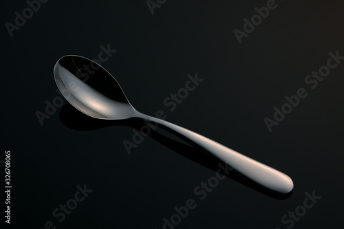teaspoon on a black mirror surface © Vladimir