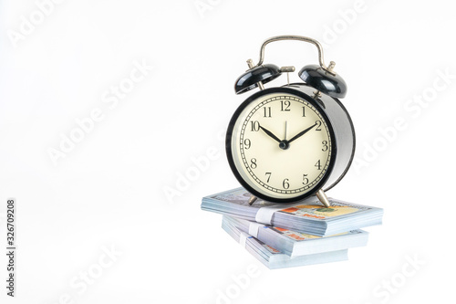 Clock and banknote with white background.