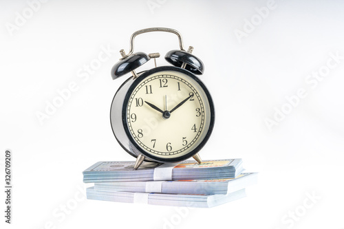 Clock and banknote with white background.