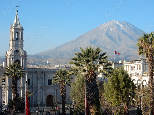 Plaza de Armas, the cathedral tower with volcanos and the Andes in the background, Arequipa, Peru photo