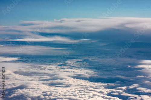 A carpet of clouds seen from the window of an airliner.