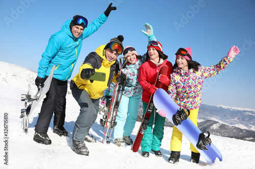 Group of friends taking selfie outdoors. Winter vacation