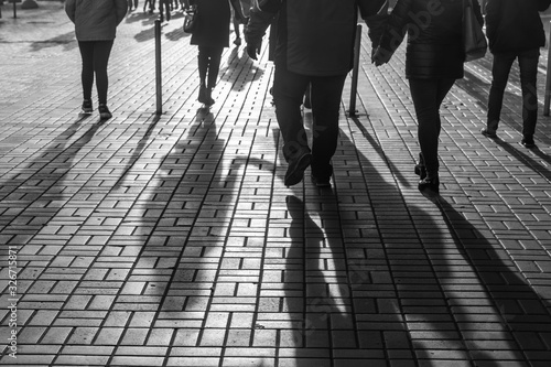 Silhouettes of people walking the streets of a big city