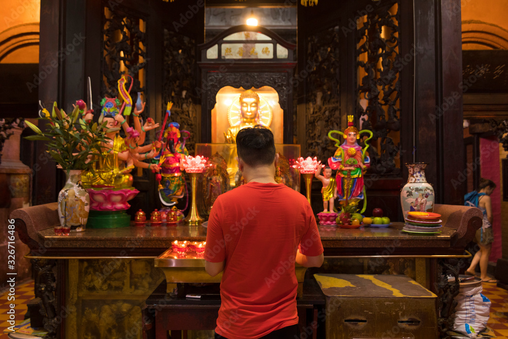 Unidentified people make a merit inside Jade Emperor Pagoda or Phuoc Hai Tu Temple in Ho Chi Minh, Vietnam