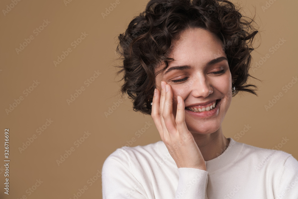 Image of joyful young woman smiling with eyes closed Image of joyful young woman smiling with eyes closed