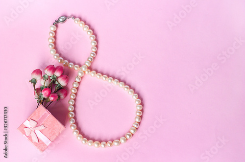 pearl necklace in the form of number 8 gift box and a bouquet of flowers on a pink background, women's day on March 8, mother's day, birthday greeting card template