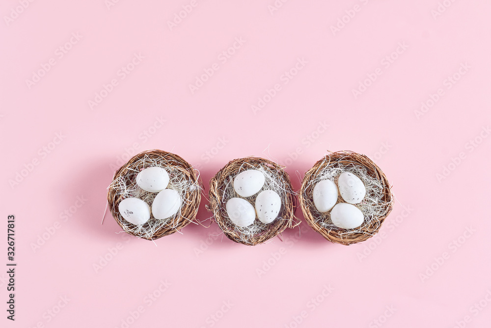 Easter composition on a pink background. decor in the form of nests with eggs. flat lay, top view Easter composition on a pink background. decor in the form of nests with eggs. flat lay, top view