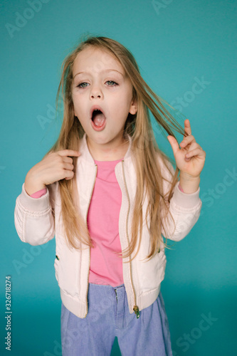 Yawing little girl. Bored child kid. Lazy expression. Lifestyle Studio portrait of young beautiful fashion girl. Emotional studio portrait of cute little girl. Portrait of smiling child